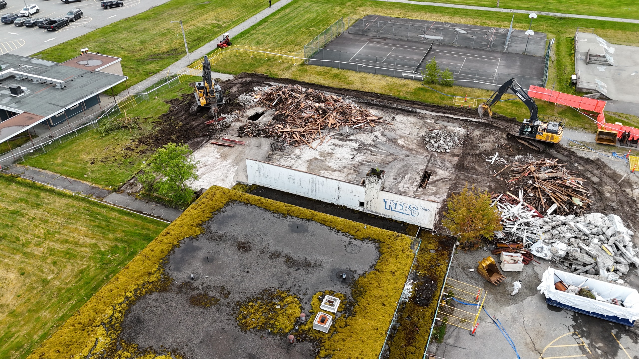 A moss covered roof of an old building, partially demolished.