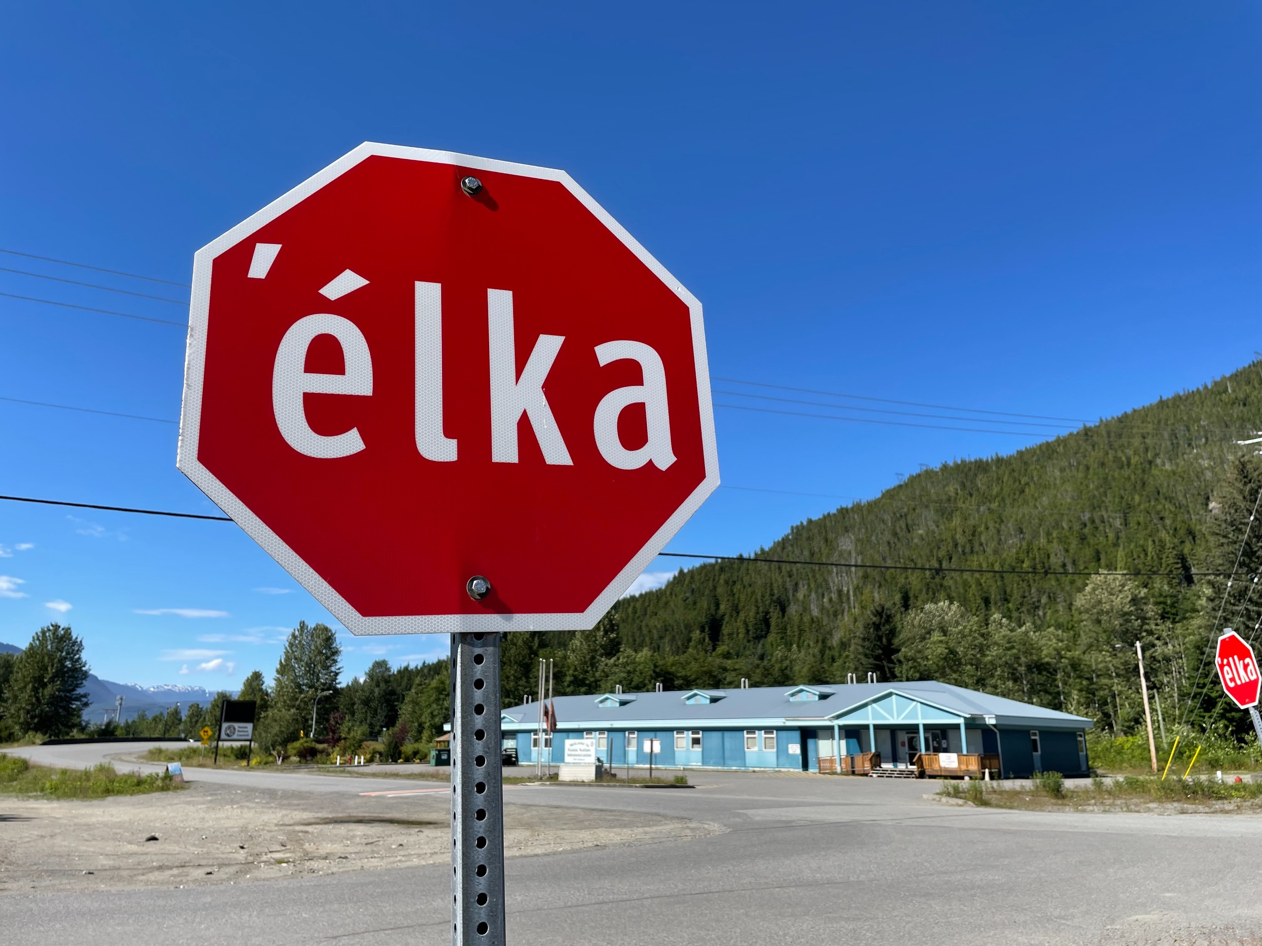 A stop sign where the word Stop has been changed to by the Haisla version.